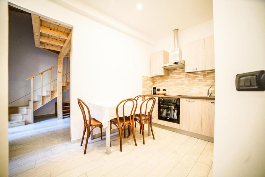 a kitchen with a table and chairs and a staircase at Casa di Matty& Lory in Sanremo