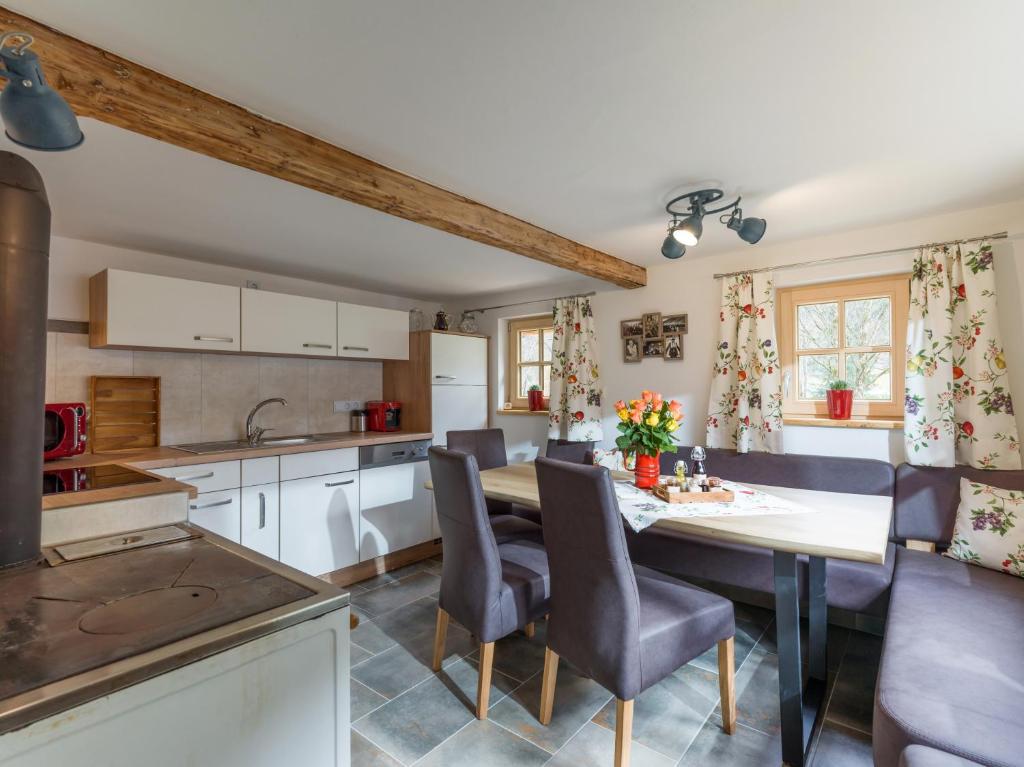 a kitchen and dining room with a table and chairs at s´Brunnhäusl in Kelchsau