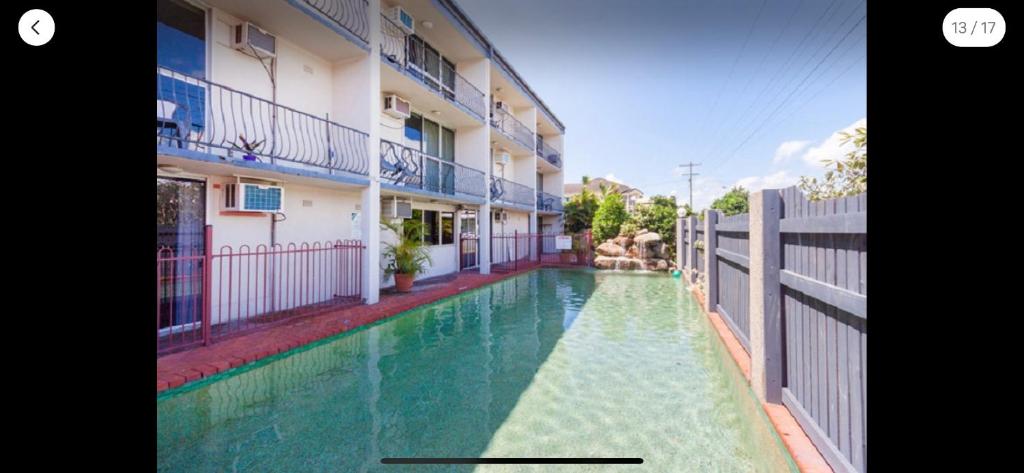 une piscine en face d'un bâtiment dans l'établissement Holiday Lodge Apartment, à Cairns North