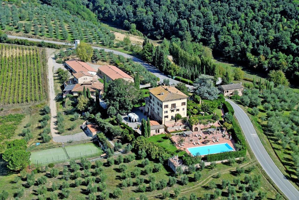 an aerial view of a house with a swimming pool at Villa Curina Resort in Castelnuovo Berardenga