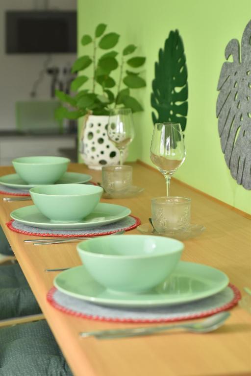 a table with plates and wine glasses on it at Apartament Centrum in Polanica-Zdrój