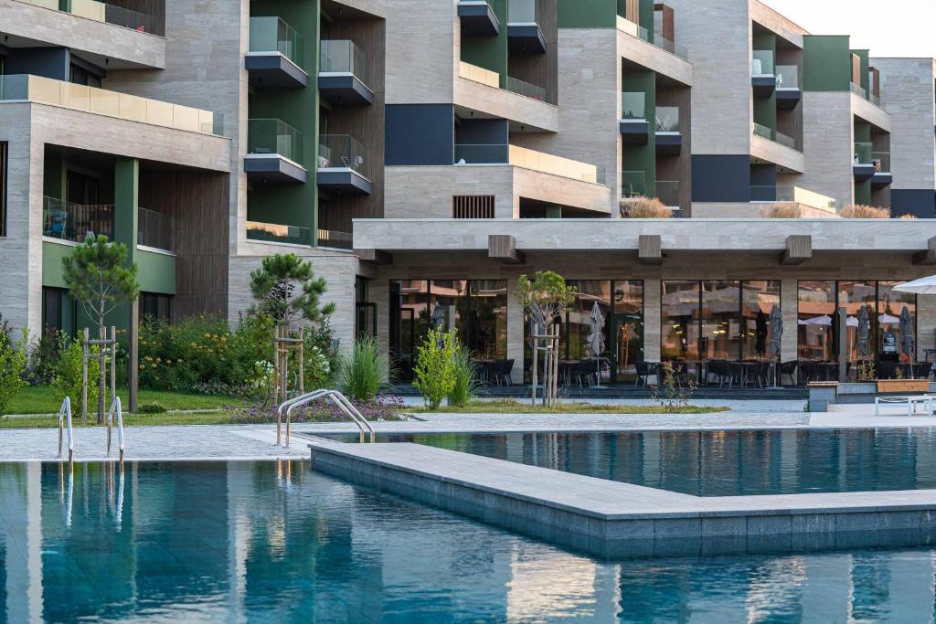 a swimming pool in front of a building at HVD Reina del Mar - Premium Spa Service & Free Parking in Obzor