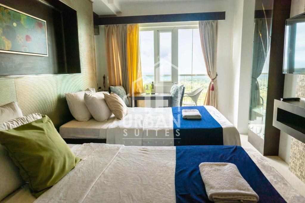 a hotel room with a bed and a couch at Wind Residences Condotel in Tagaytay