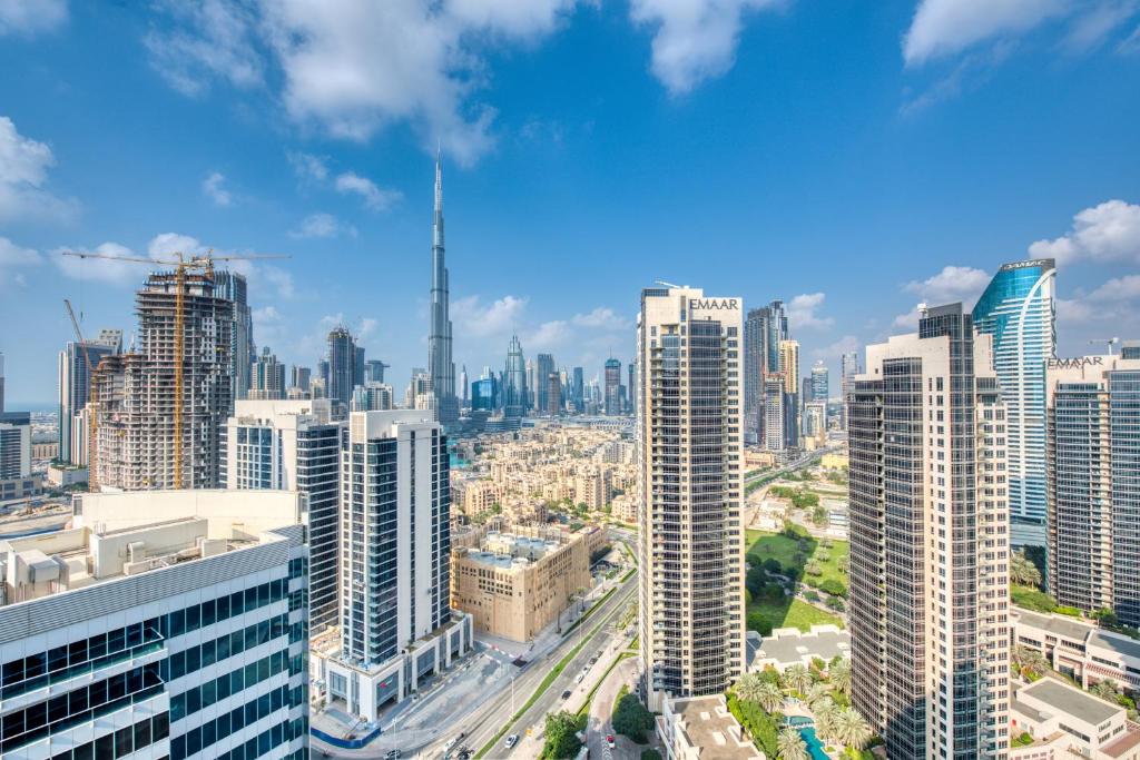 an aerial view of a city with tall buildings at Maison Privee - Luxury, Spacious, Modern Near Burj Khalifa and Dubai Canal in Dubai