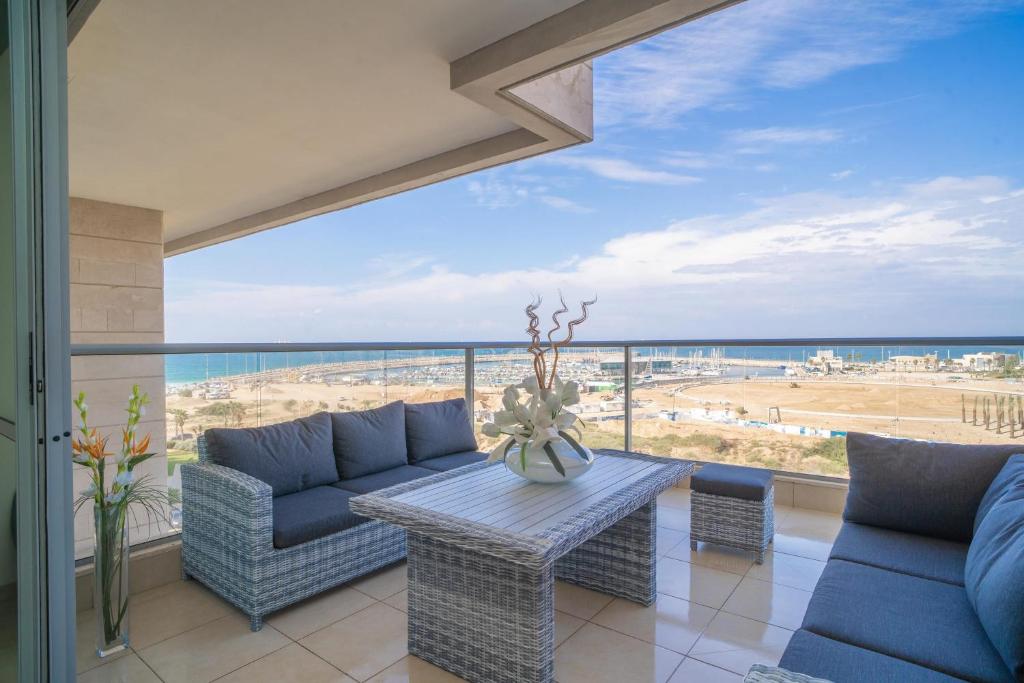 a living room with a view of the beach at Luxury Marina Beachfront by Airsuite in Ashdod