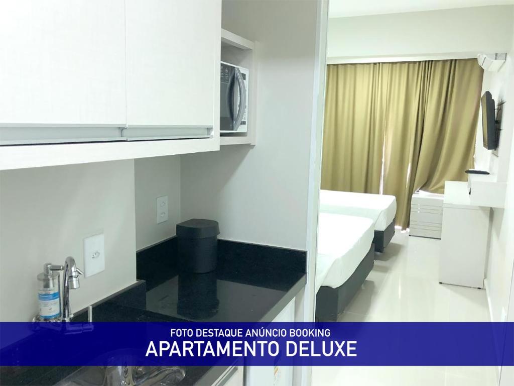 a hospital room with a bed and a microwave at Nox Apart Hotel - Garvey in Brasilia