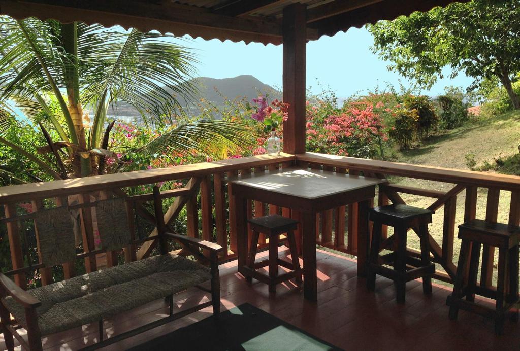 a table and chairs on a porch with a view at Large Cottage Rodney Bay 2 bedrooms 2 bathrooms in Gros Islet