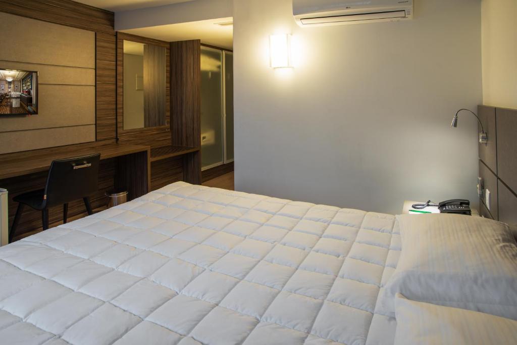 Postel nebo postele na pokoji v ubytování Hotel Laghetto Moinhos