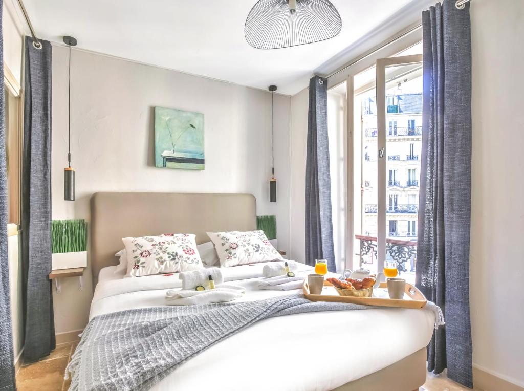 a bedroom with a white bed and a window at 834 - Spacious flat in Paris Olympic Games 2024 in Paris