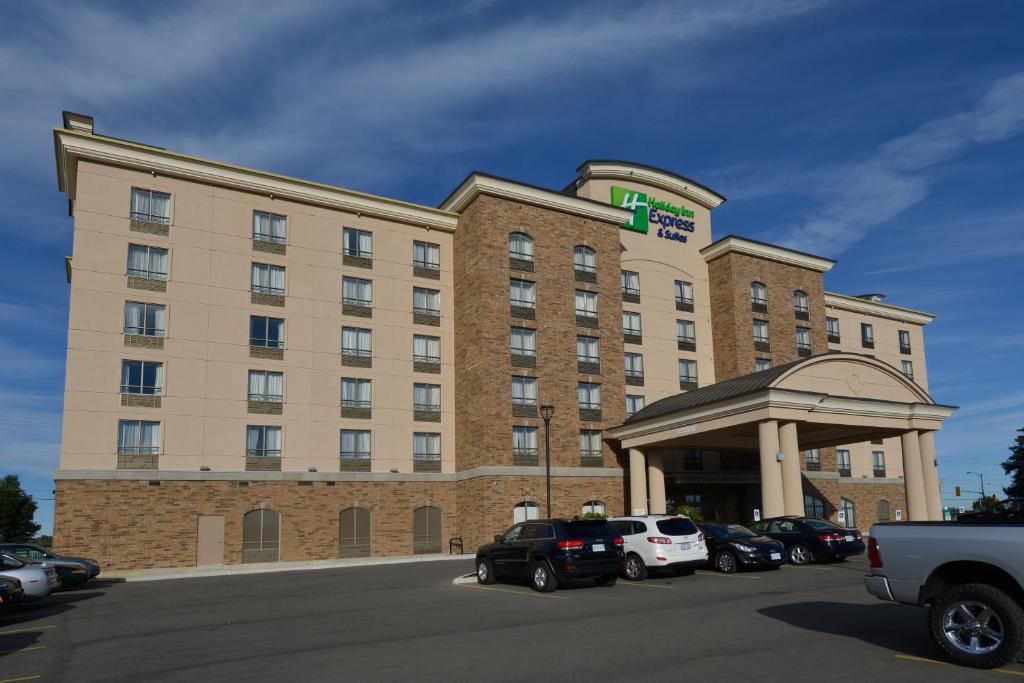 a hotel building with cars parked in a parking lot at Holiday Inn Express Hotel & Suites Waterloo - St. Jacobs Area, an IHG Hotel in Waterloo