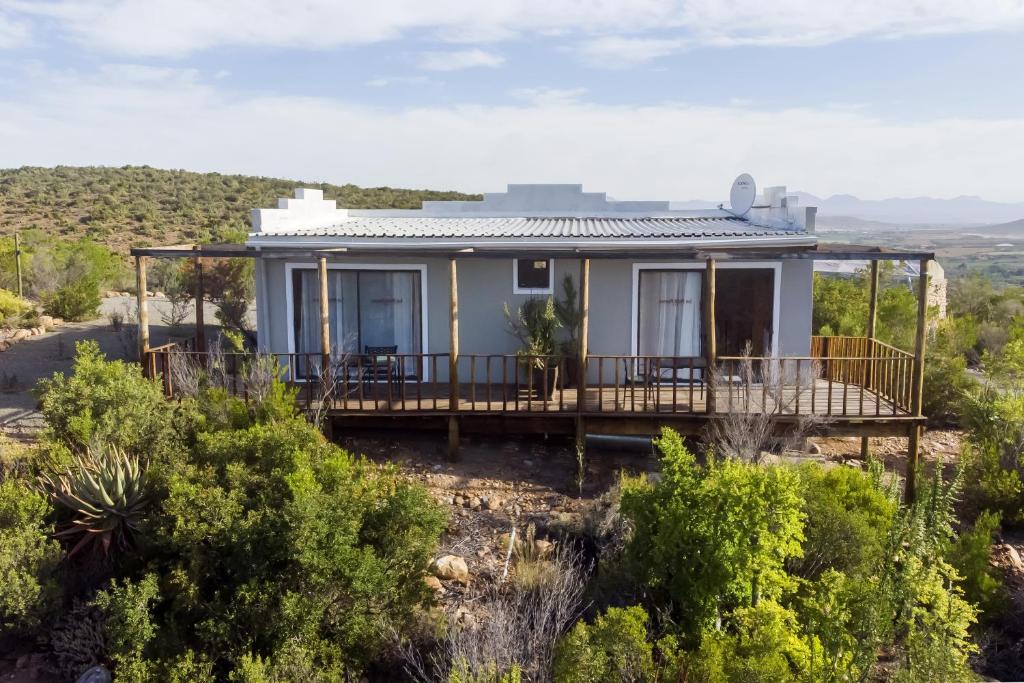 a house on a hill with a deck at Le Petit Karoo Ranch in Oudtshoorn