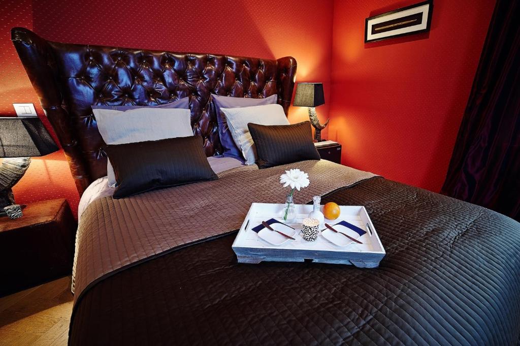 a bedroom with a large bed with a tray on it at B&B Au Clair Obscur in Verviers