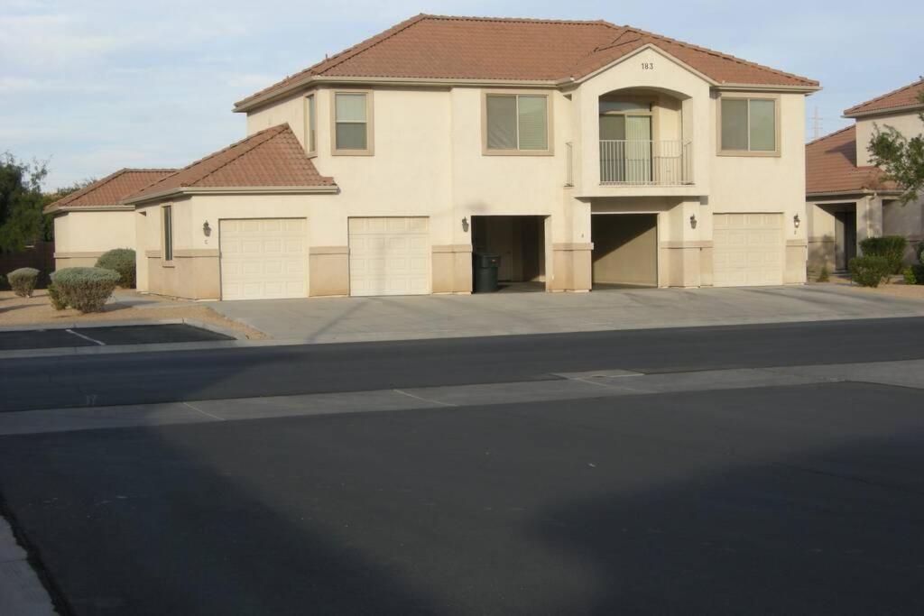 a house on a street with at Mesquite Nevada Vacation Rental - Ground Level and double car garage in Mesquite