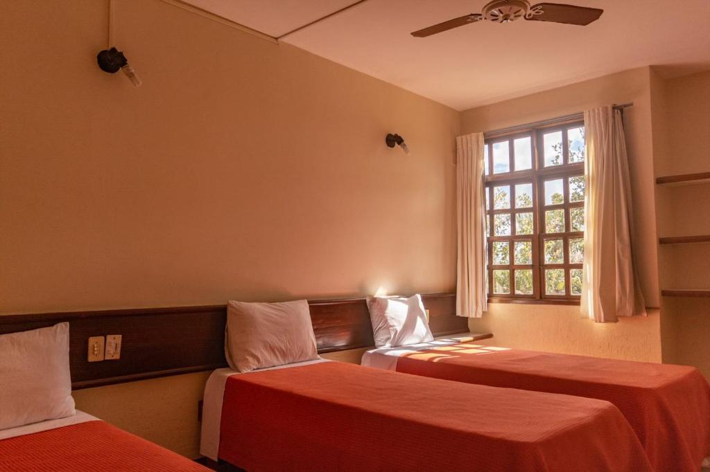 Cama ou camas em um quarto em Casarão Alpina