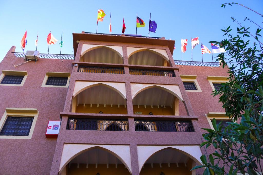 a building with flags on top of it at Dar Diafa Kaltom in Ouzoud