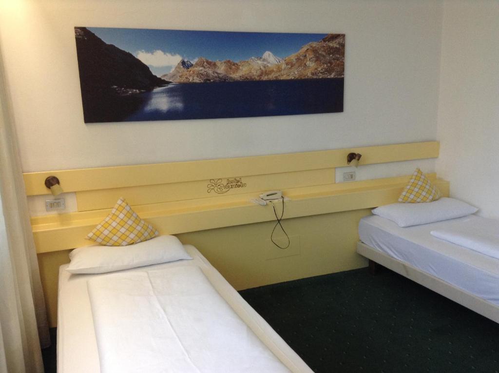 Postel nebo postele na pokoji v ubytování Hotel Daniela