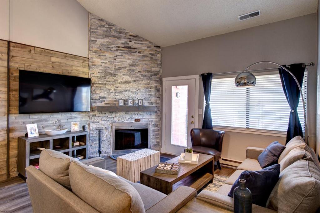 a living room with a couch and a fireplace at Giant Steps 53 Ski In-out in Brian Head