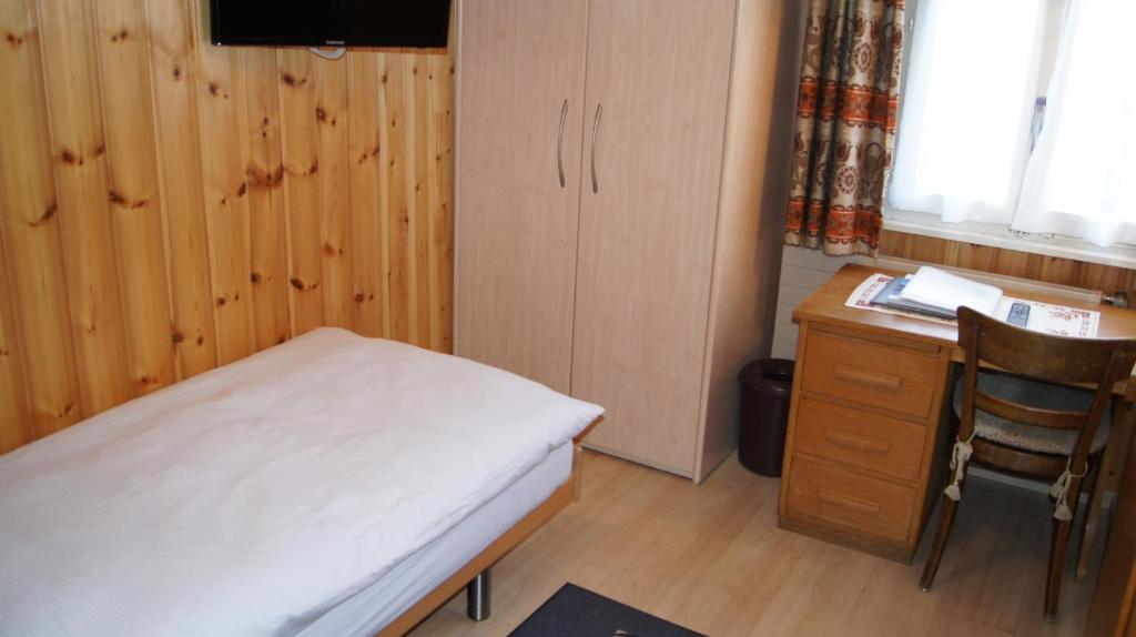 Postel nebo postele na pokoji v ubytování Hotel Alpina