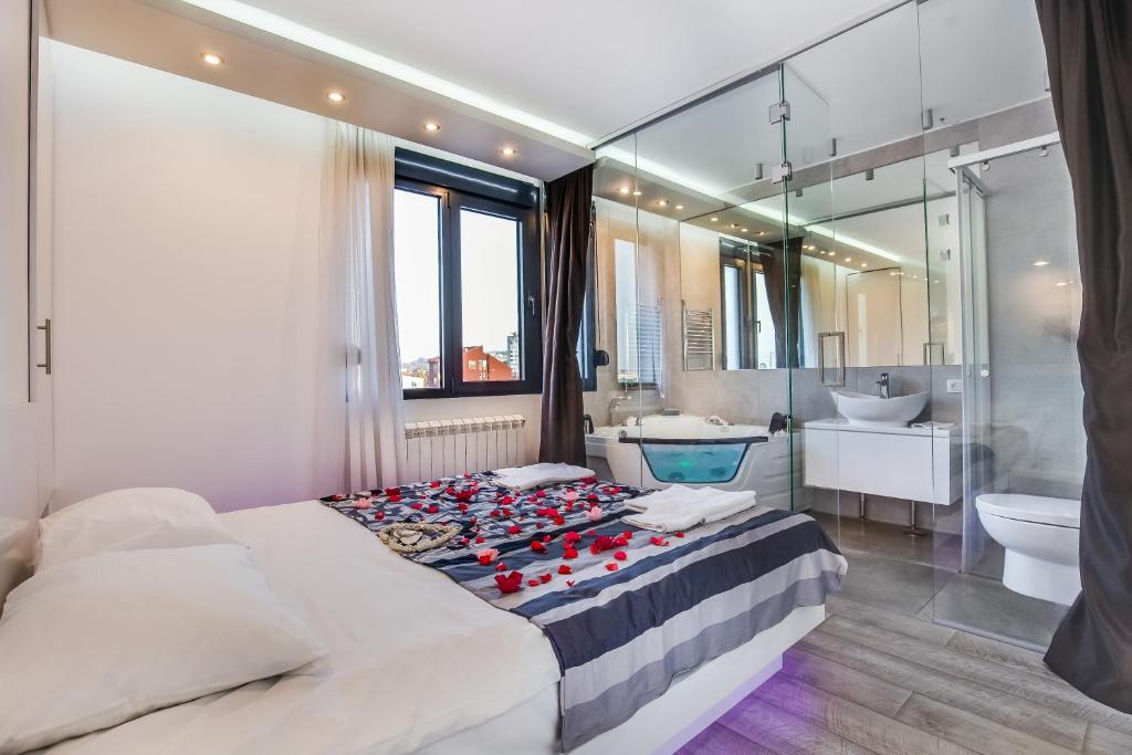 a bedroom with a large bed and a bathroom at Luxury Boutique City Center Apartments in Belgrade