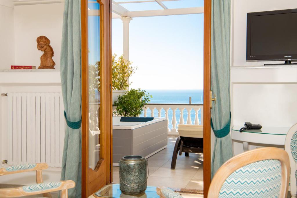 a living room with a view of the ocean at Hotel Villa Gabrisa in Positano