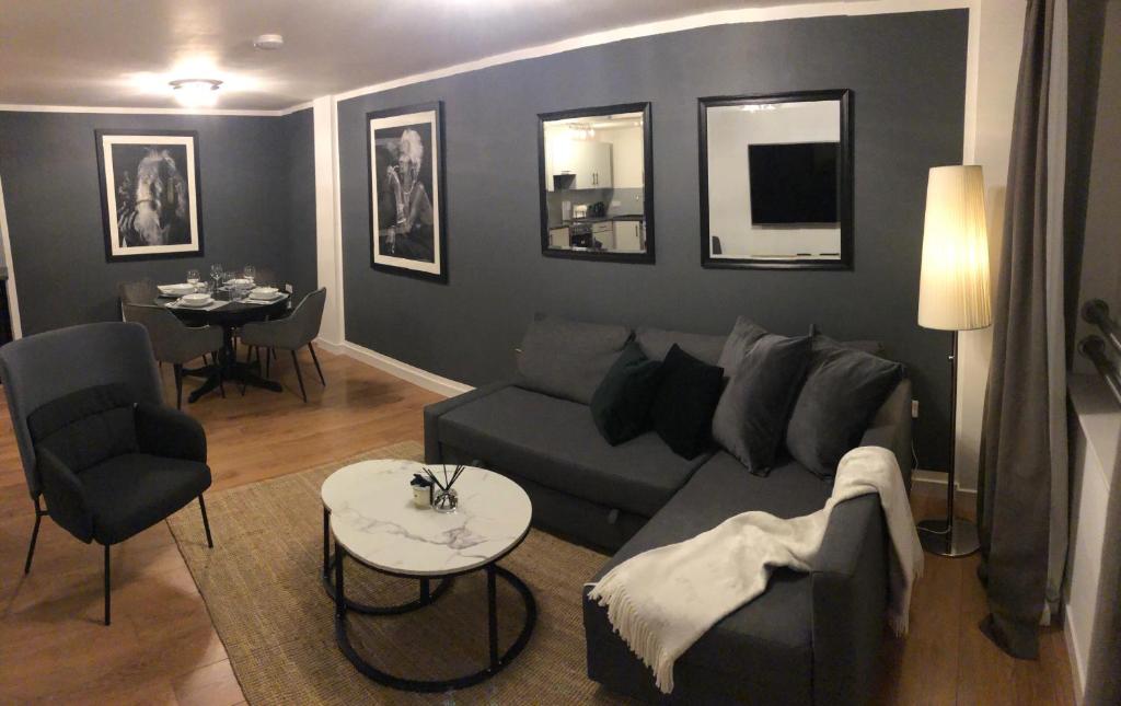 a living room with a couch and a table at GRAPHITE APARTMENTS in Inverness