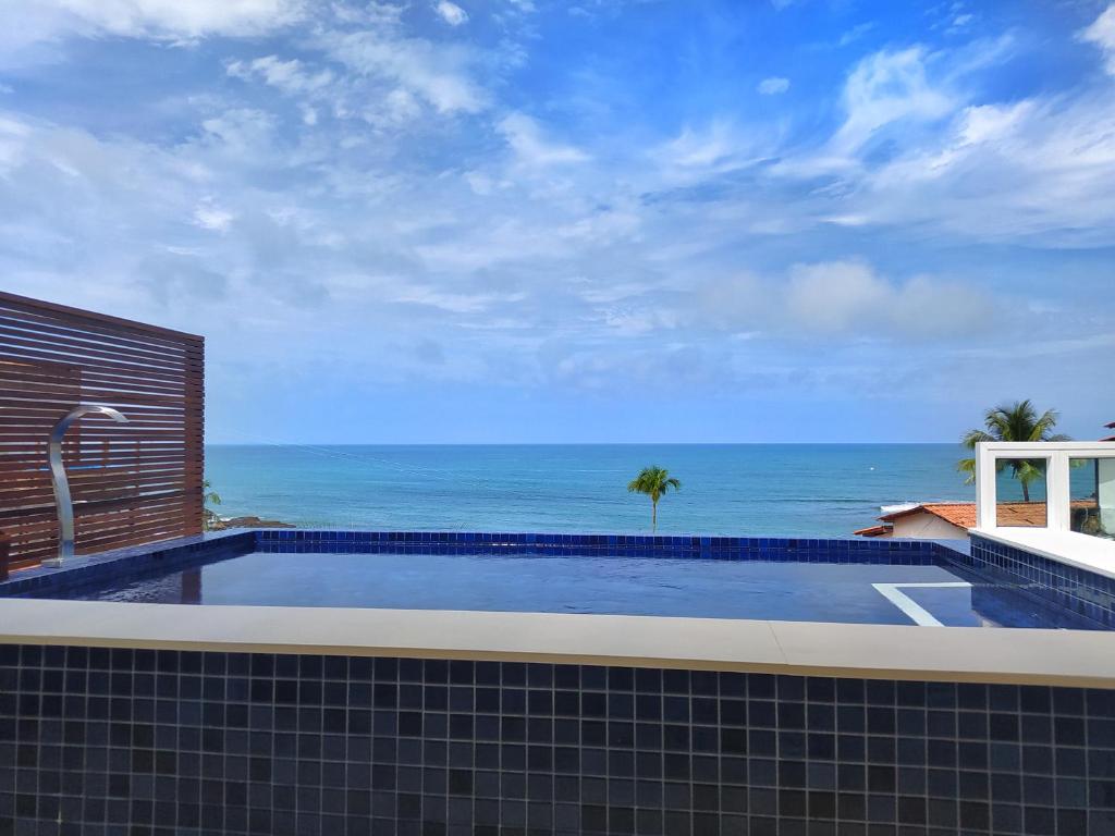 a swimming pool with a view of the ocean at Pousada Vila Dos Mares in Morro de São Paulo