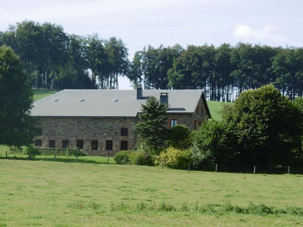 Stara kamienna stodoła na polu z drzewami w obiekcie Quaint Holiday Home in Gouvy with Sauna w mieście Rogery
