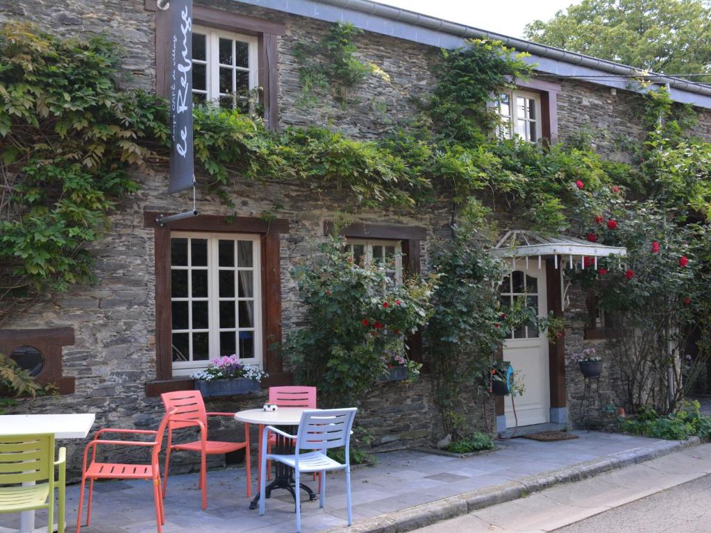 a table and chairs in front of a building at Charming house with fireplace in Bièvre