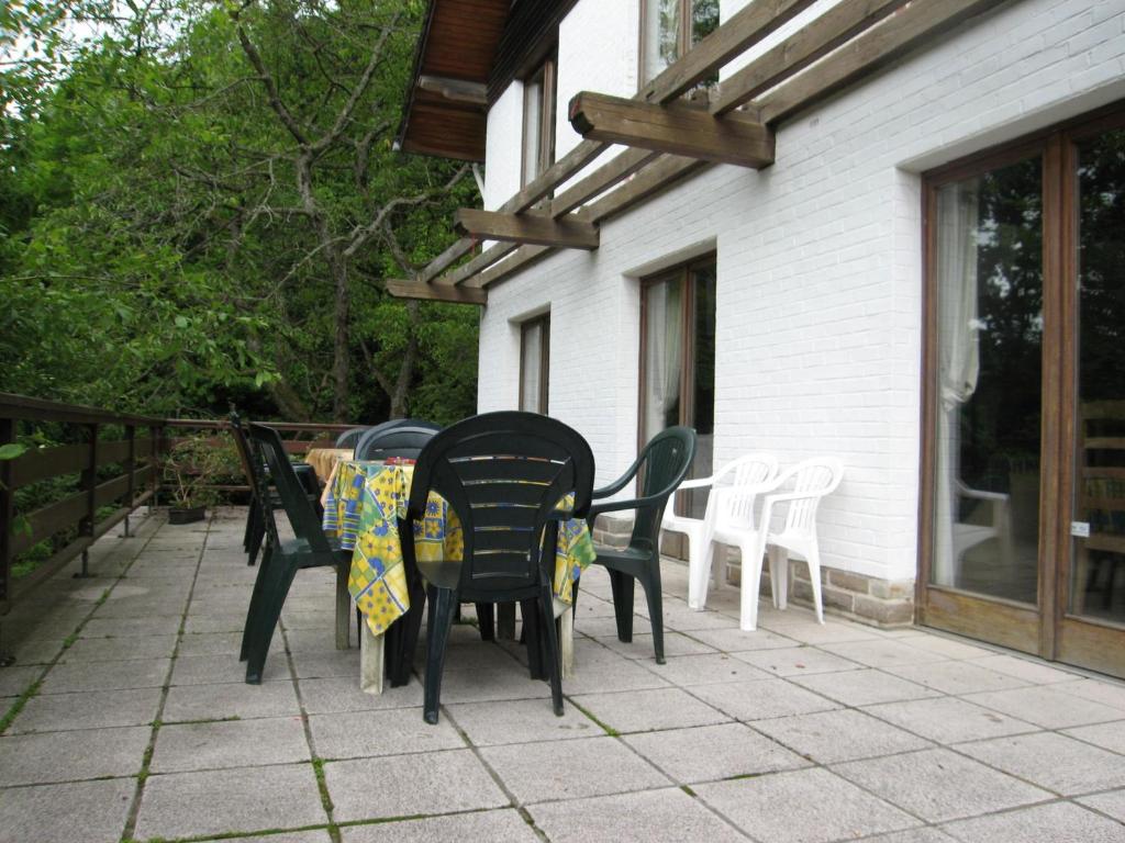 a patio with chairs and a table on a patio at Amazing Chalet in Stavelot with Garden in Stavelot