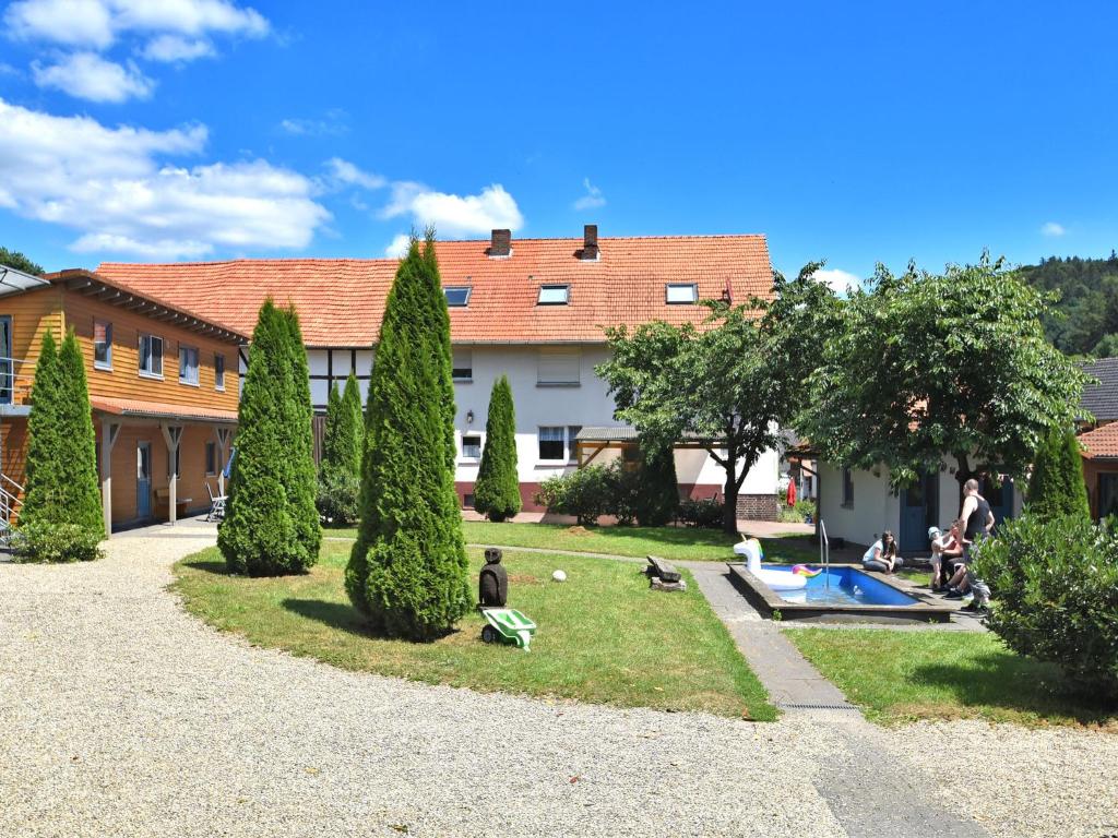 a group of people in a yard with a pool at farm situated next to the Kellerwaldnational park in Bad Wildungen