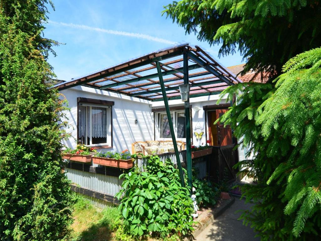 a house with a pergola on the side of it at Holiday home in Cattenstedt Harz with garden in Cattenstedt