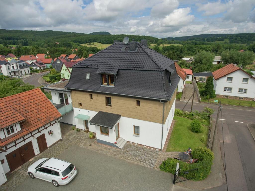 ein Haus mit einem davor geparkt in der Unterkunft Holiday flat near the river in Winterstein in Emsetal