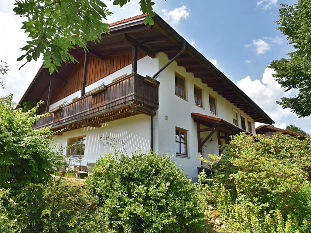 a white house with a balcony on the side of it at Cottage in Rinchnach Bavaria near the forest in Rinchnach