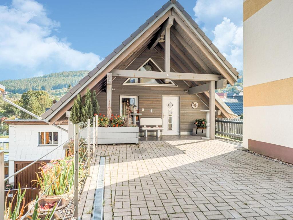 a house with a pitched roof with a patio at Apartment with barbecue in M hrenbach in Möhrenbach