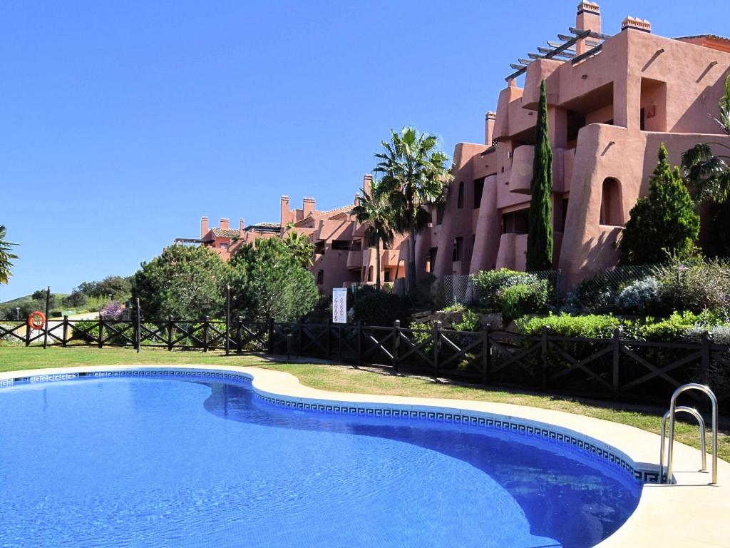 a large swimming pool in front of a building at Belvilla by OYO El Soto de Marbella in Ojén