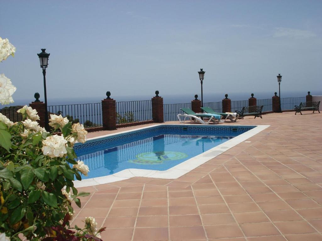 a swimming pool on the roof of a house at Belvilla by OYO Casa Mirador in Nerja