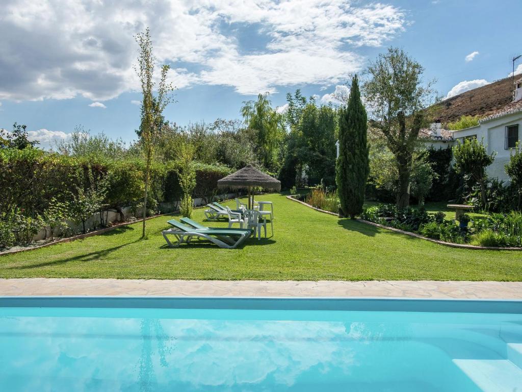 a villa with a swimming pool and a house at Belvilla by OYO Molinos de Padul Se a Anica in Padul