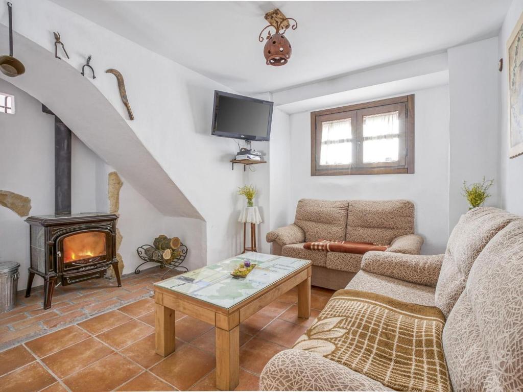 salon z kanapą i kominkiem w obiekcie Villa in Carcabuey near Sierras Subbeticas Park w mieście Carcabuey