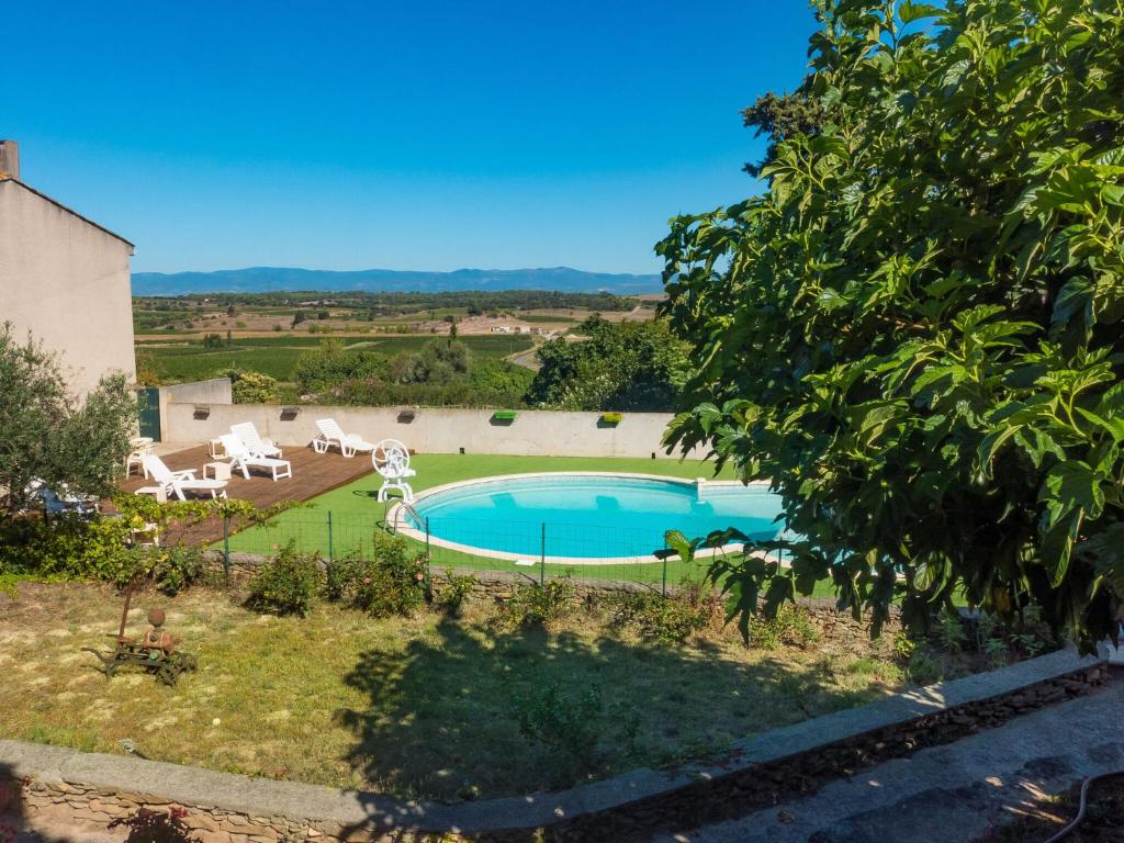 a view of a swimming pool in a garden at Stone cottage on an active wine growing estate with a swimming pool in Conilhac-Corbières