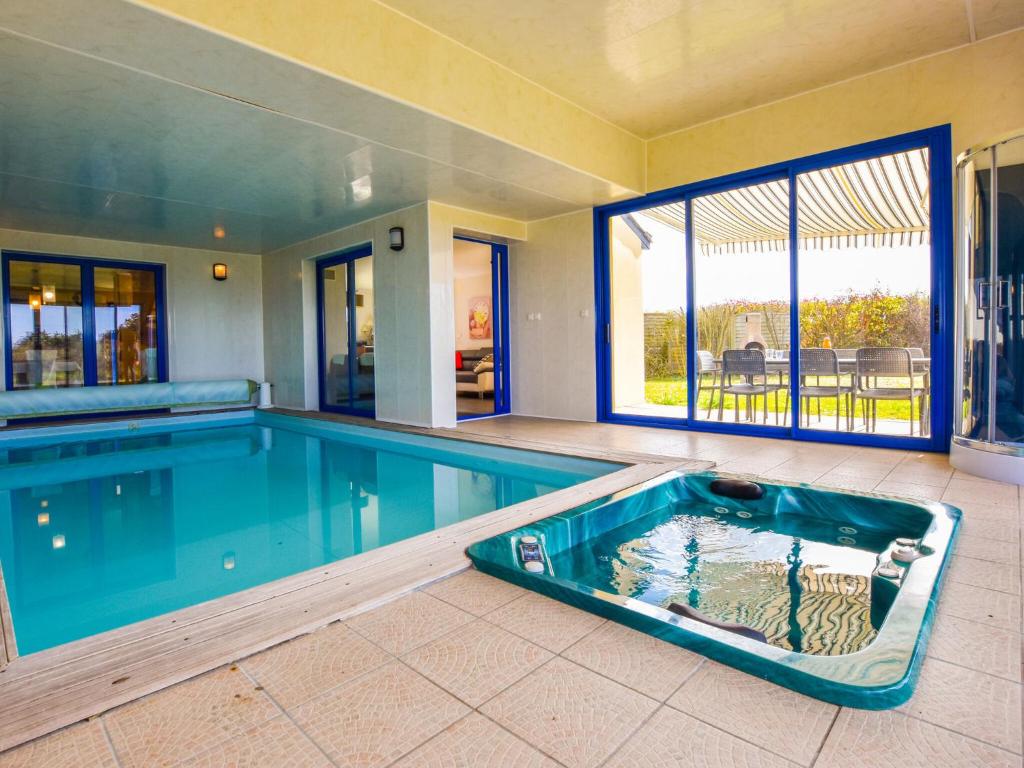 a large swimming pool in a house at Villa with indoor pool jacuzzi sauna in Moëlan-sur-Mer