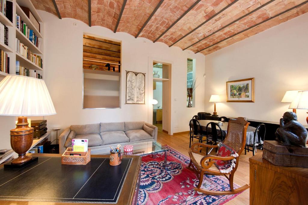 a living room with a couch and a table at Habitat Apartments La Bohème in Barcelona