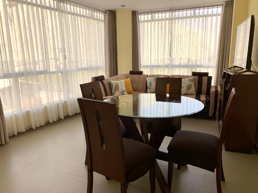 a living room with a table and a couch at LA CASA BLANCA in Lunahuaná