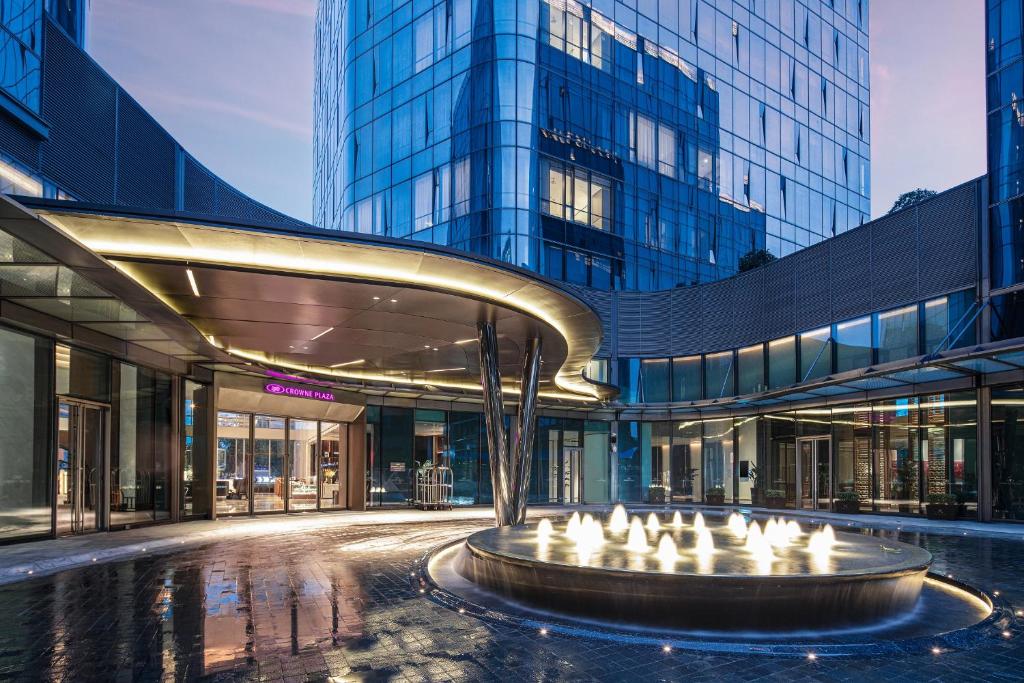 a large building with a fountain in front of it at Crowne Plaza Shanghai Hongqiao by IHG in Shanghai