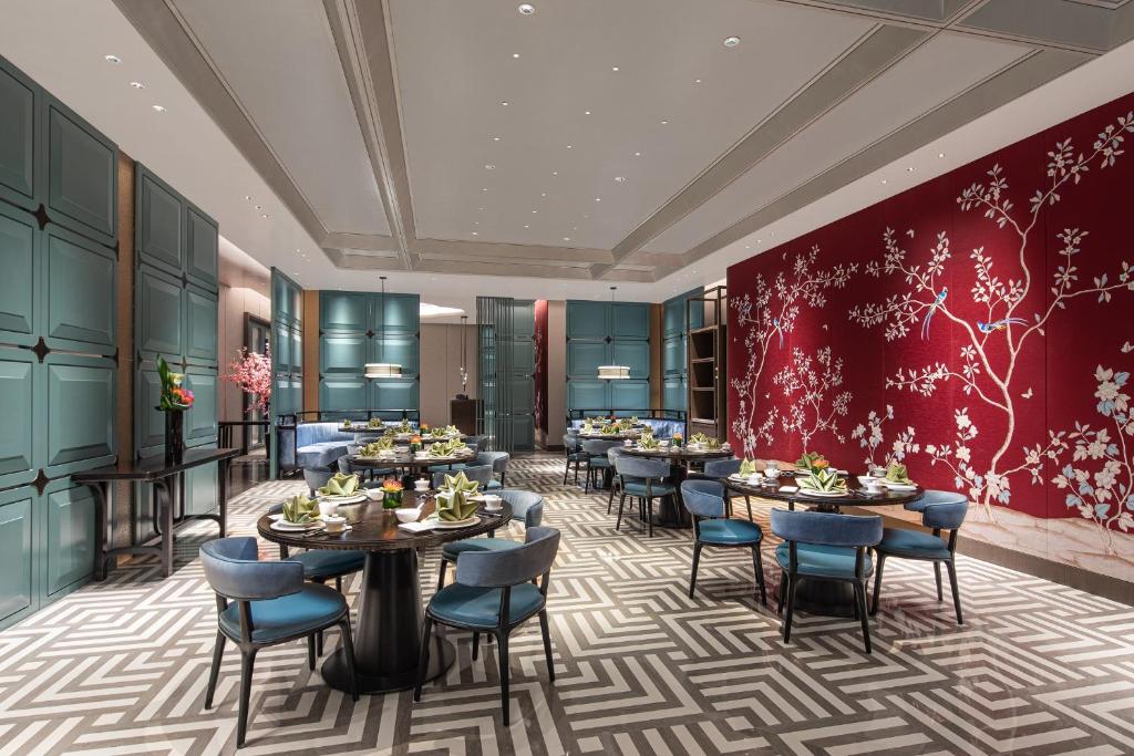 a rendering of a restaurant with tables and chairs at Crowne Plaza Shanghai Hongqiao by IHG in Shanghai