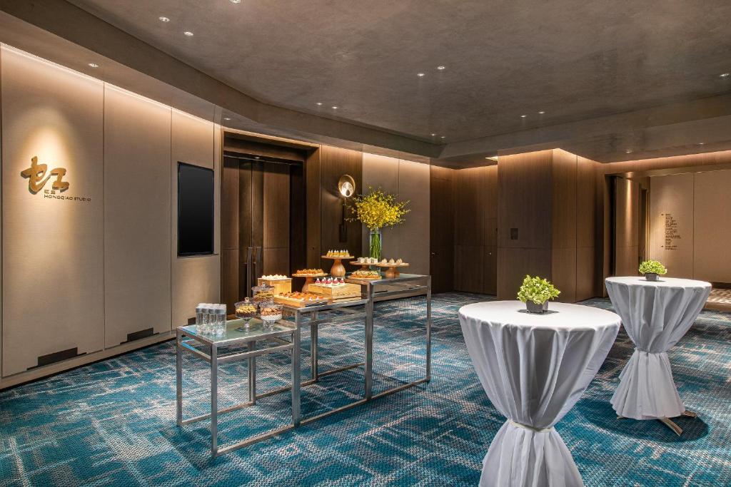 a hotel lobby with two tables with food on it at Crowne Plaza Shanghai Hongqiao by IHG in Shanghai