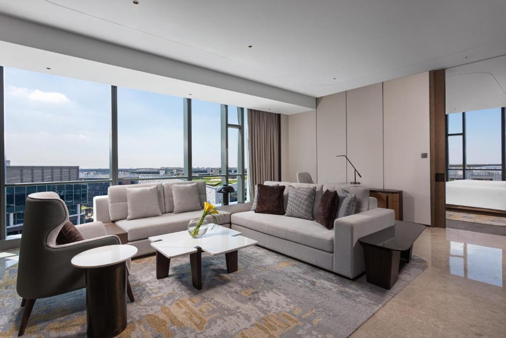 a living room with two couches and a table at Crowne Plaza Shanghai Hongqiao by IHG in Shanghai