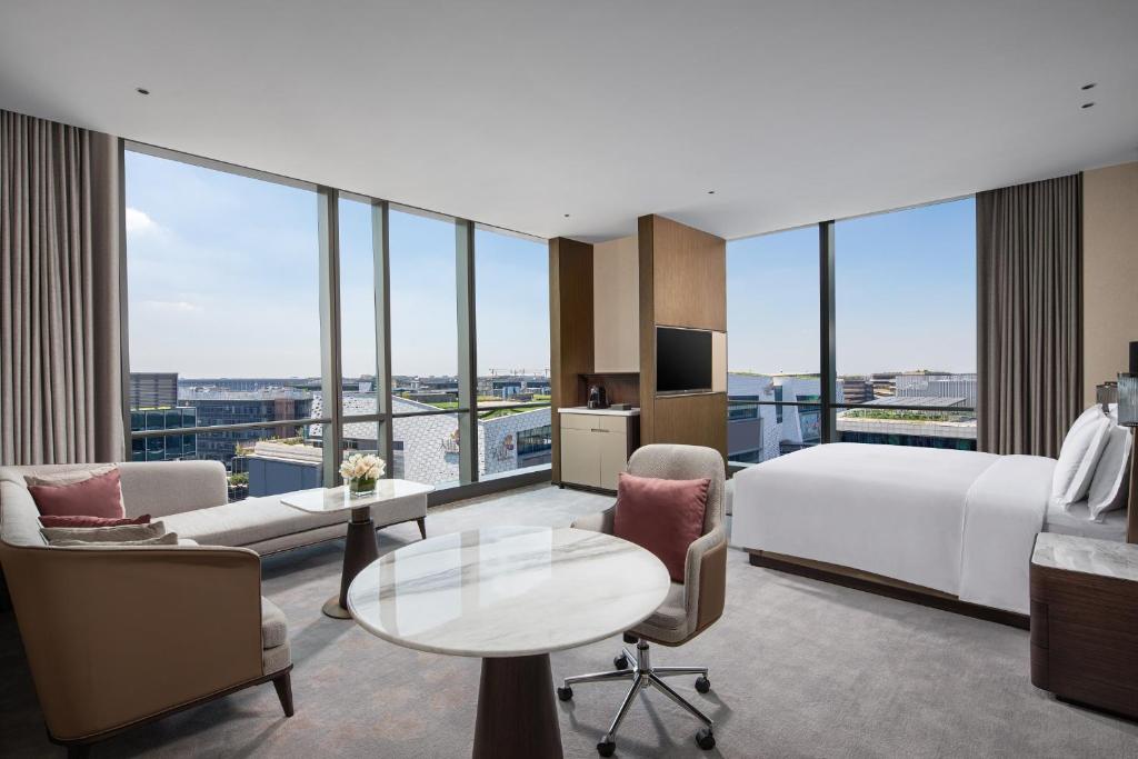 a hotel room with a bed and a large window at Crowne Plaza Shanghai Hongqiao by IHG in Shanghai