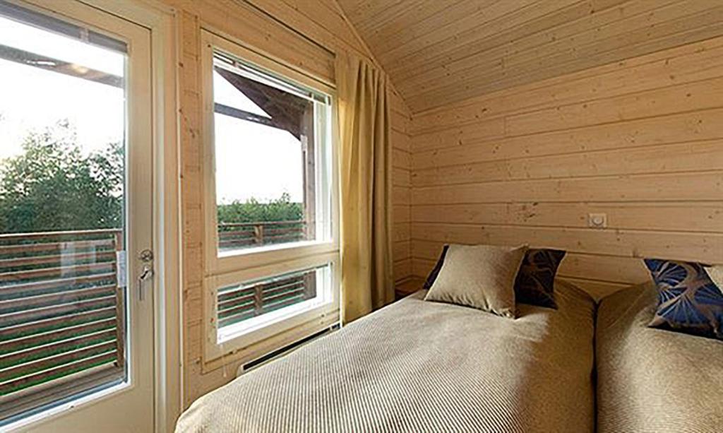 a bedroom with a bed next to a window at Holiday Club Himos Apartments in Jämsä