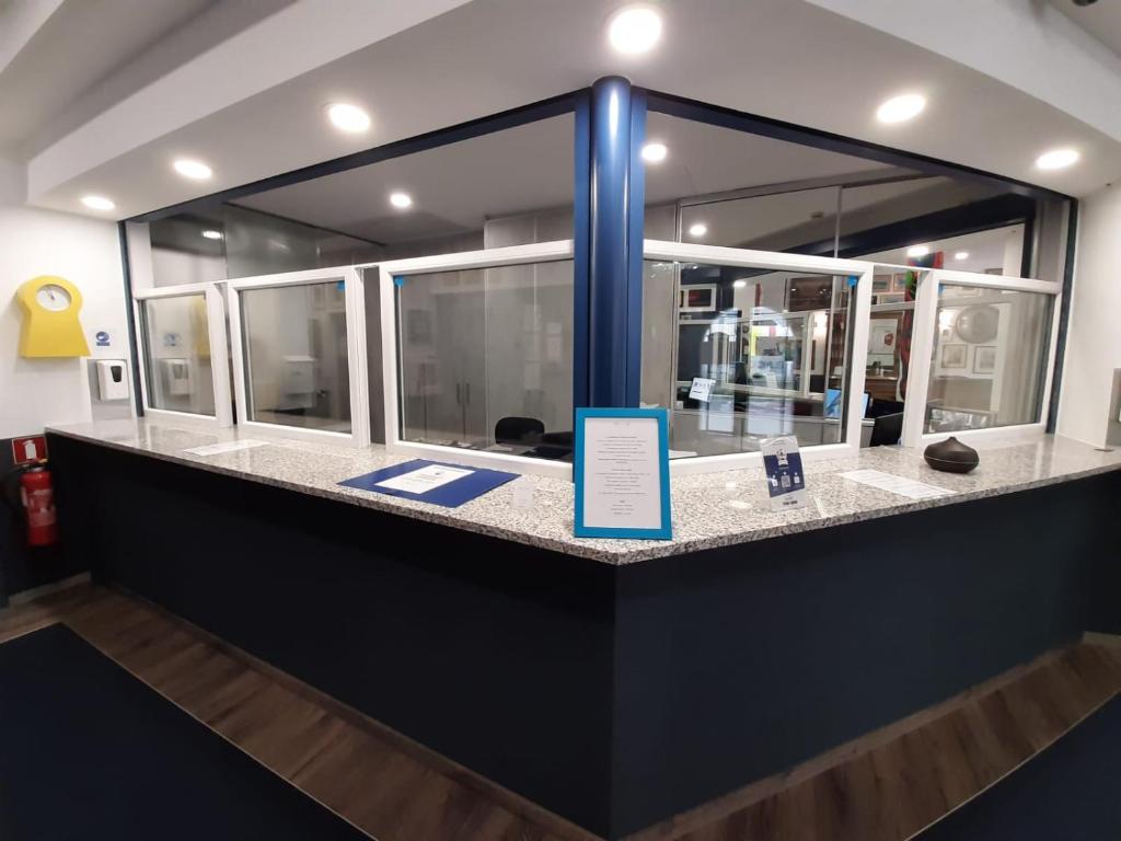 a counter in a building with a sign on it at Domus Hotel in Luxembourg