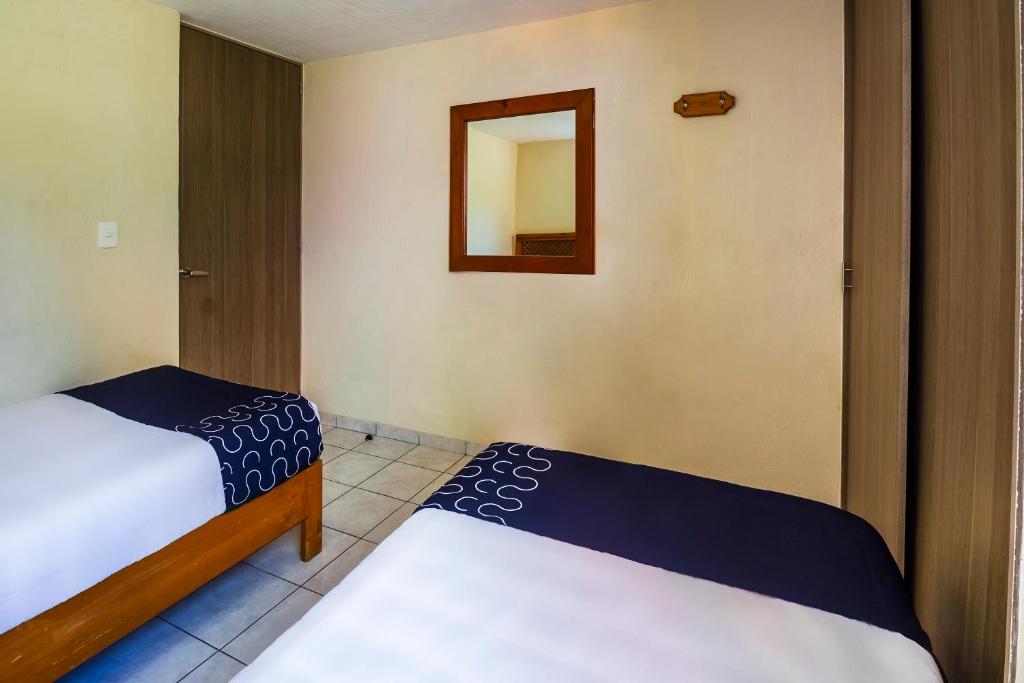 Postel nebo postele na pokoji v ubytování Suites Navata